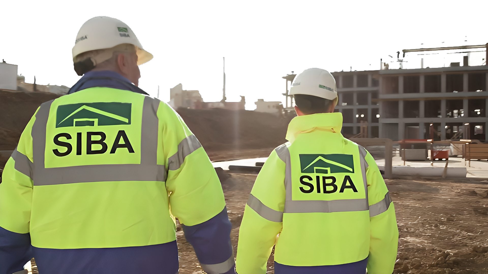 Two SIBA workers in hi-vis jackets walking at a construction site